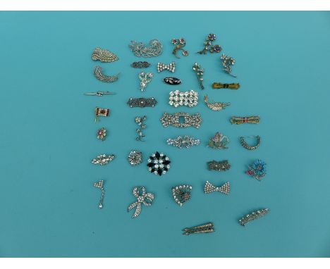A collection of brooches to include floral brooches, enamel, marcasite and a Canadian flag example