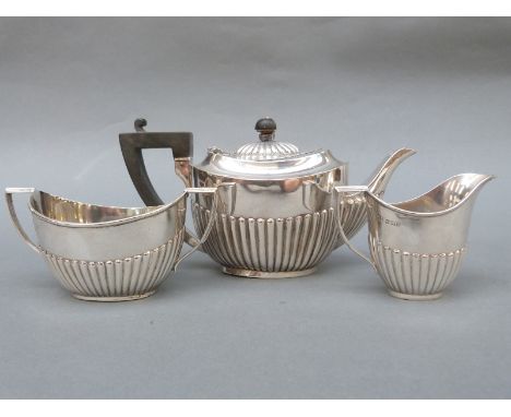 An Edward VII / George V hallmarked silver bachelor's tea set with fluted lower setion, teapot London 1909 maker Page, Keen &