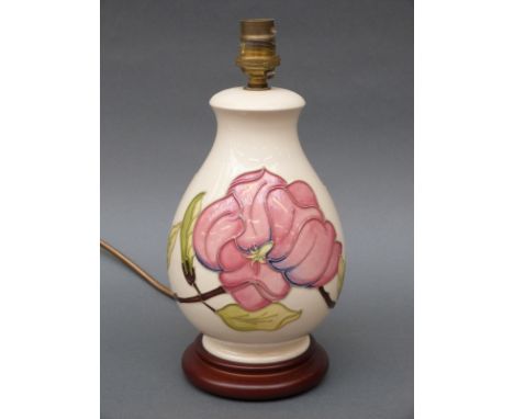 A Moorcroft table lamp in the Hibiscus pattern on cream ground, 27cm tall