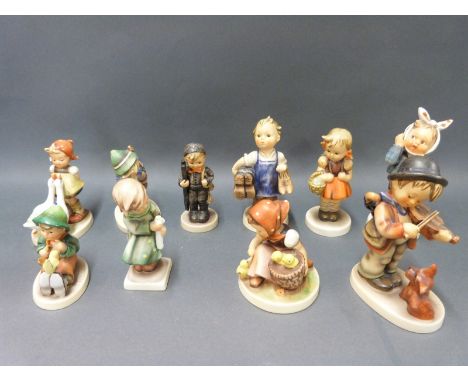 Ten Goebel Hummel figures including boy with ladder, boy playing the violin to a dog etc