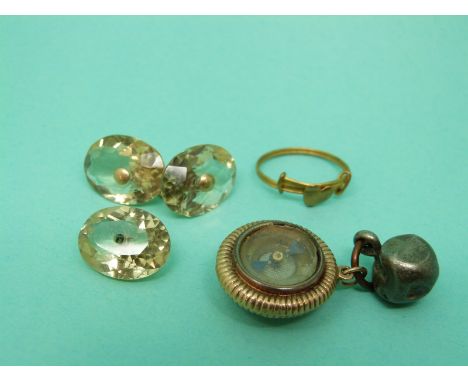 A yellow metal fob set with a compass and a citrine cufflink