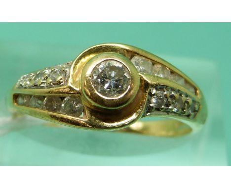 An 18ct gold ring set with a round brilliant cut diamond to the centre and further diamonds to the shoulders (Size K), weight