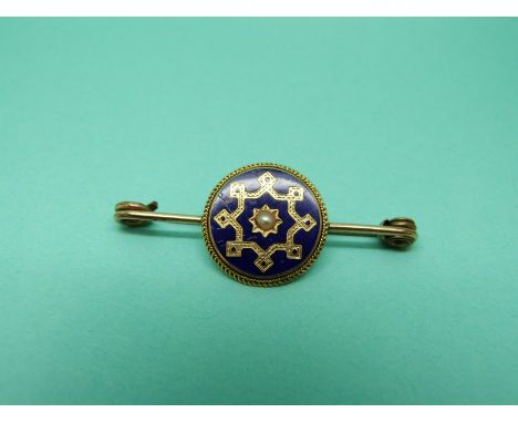 A Victorian brooch set with blue enamel and a pearl to the centre