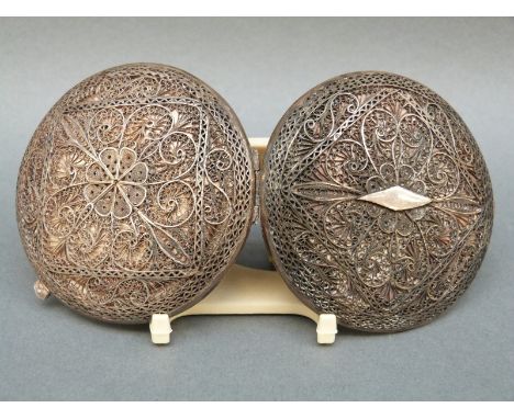 A white metal filigree compact with scrolling floral design, diameter 7cm, weight 82g all in