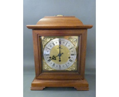 A German c1970 mahogany cased mantel clock, the movement by Kleninger, with three chimes and brass dial with cherub spandrels