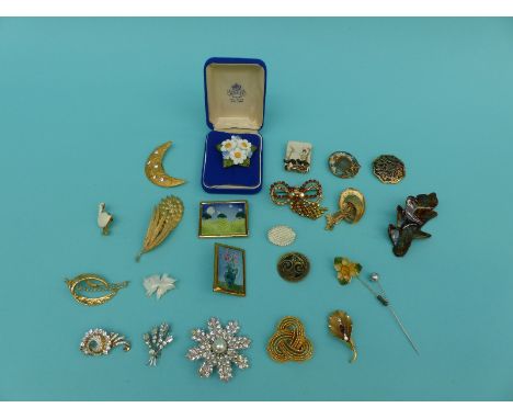 A collection of brooches set with paste, ceramic examples etc to include 'Ecco'
