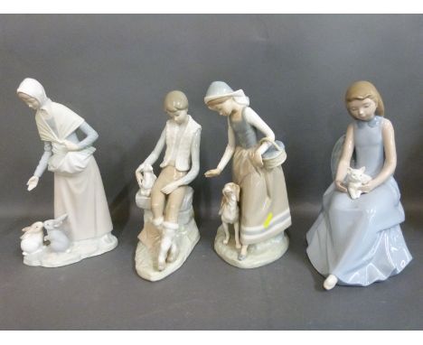 Four Nao figures including boy with lamb, girl with kitten, girl with dog and girl with rabbits