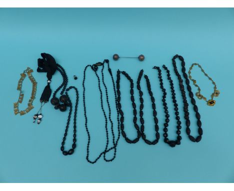 A collection of jet jewellery including carved necklaces, French jet, Victorian pinchbeck necklace set with onyx and seed pea