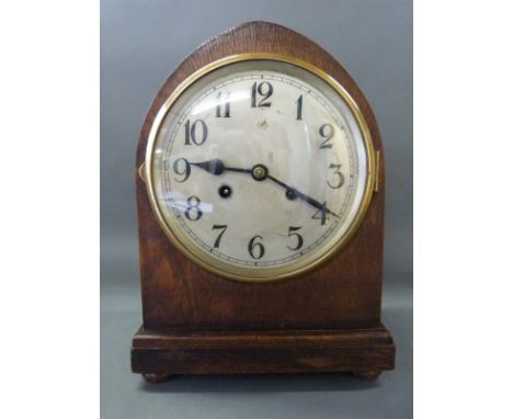 An oak mitre cased c1930 two train mantel clock with Arabic dial raised on bun feet, 31cm tall 