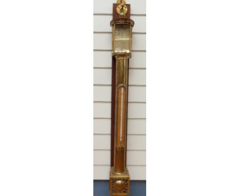 A brass marine barometer signed Negretti and Zambra, London, the tubular form case with silvered requiter plate callibrated a