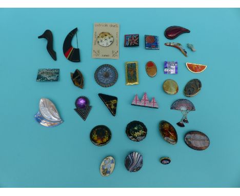 A collection of wooden and enamel brooches including Russian lacquered examples, Ostrich shell, ceramic etc