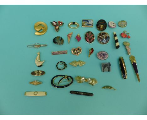 A collection of brooches including enamel, one in the form of a geisha girl, a Stratton tie clip, enamel by fish, Monet, Chri