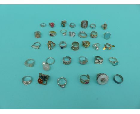 A collection of 33 silver/white metal dress rings including ruby, pearl, citrine etc