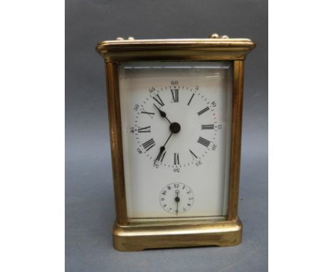 A French corniche cased brass carriage clock with strike and alarm facility and Roman enamel dial with Arabic minutes 
