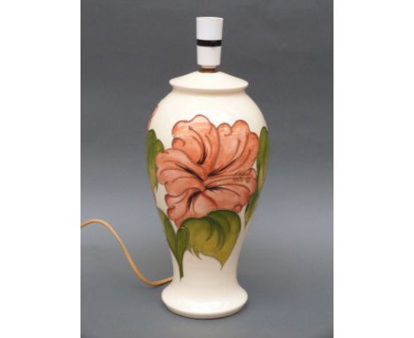 A Moorcroft lamp in the Hibiscus pattern on cream ground, 40cm tall