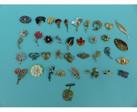 A collection of brooches in floral and foliate design to include enamel set etc