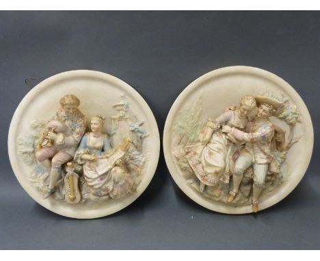 A pair of ceramic relief figural plaques