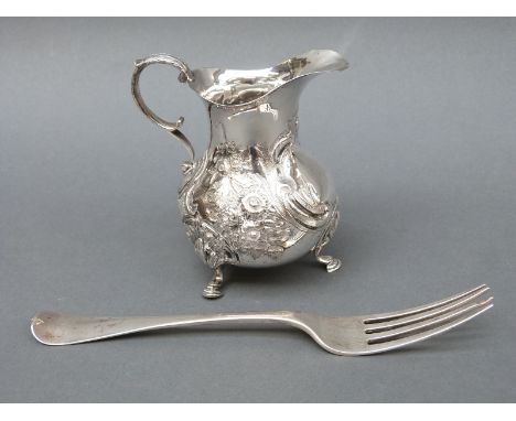 A Victorian hallmarked silver cream jug raised on three feet, London 1874, maker's mark EE FE, height 11cm, weight 163g and a