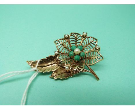 A 9ct gold brooch in a floral design set with turquoise and pearl, 7g