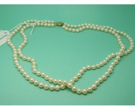 A double strand pearl necklace with 14ct gold clasp
