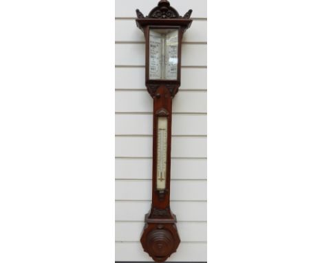 Troughton & Simms 19thC mahogany stick barometer with carved and turned decoration to case. The white glass dial calibrated w