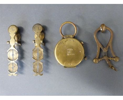 Two sovereign scales, one Harrison the other Smith, brass skirt lifter and a brass marching compass marked Cruchon & Emons Be