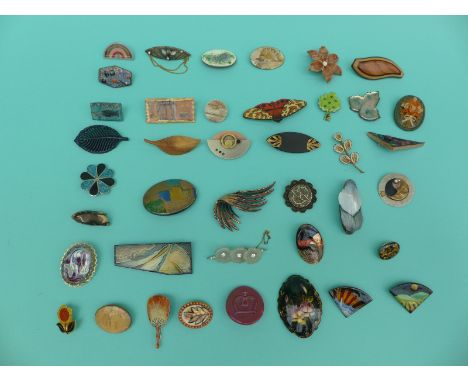 A collection of brooches to include enamel floral examples, wooden brooch, signed Russian lacquered etc