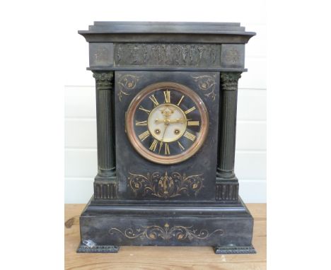 A large black slate mantel clock with open escapement 