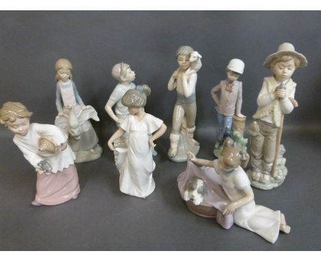 A collection of Nao child figures including boy with puppy, girl with goose, newspaper boy and boy with lamb