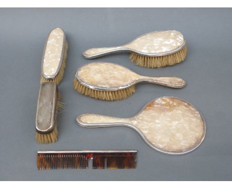 A hallmarked silver dressing table set comprising hand mirror and four various brushes, together with a hallmarked silver-mou