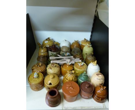 A collection of over twnety ceramic honey pots etc