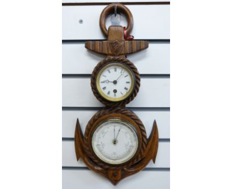 A late 19thC oak cased clock barometer carved in the form of a rope and anchor, the enamelled Roman clock dial with breguet s