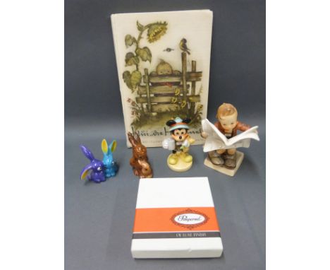 Four Goebel Hummel figures including boy reading newspaper, Mickey Mouse and unusual rabbits, Hummel interest coasters and a 