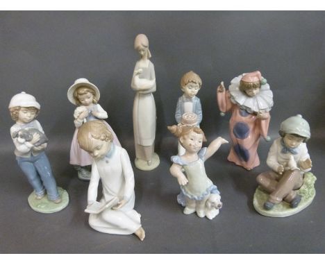 A collection of Nao child figures including boy with cake, clown with puppy etc