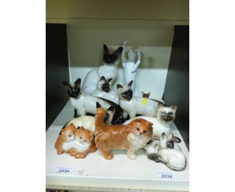 A collection of Beswick and Royal Doulton cat models, mostly Siamese 