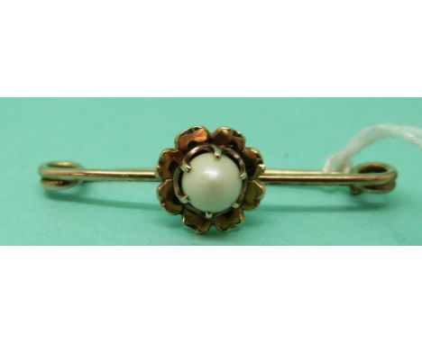 A 9ct gold brooch in the form of a flower with a freshwater pearl to the centre