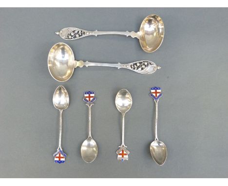 A set of four hallmarked silver enamel spoons, motto possibly relates to Mill Hill School, weight 52g all in, together with a