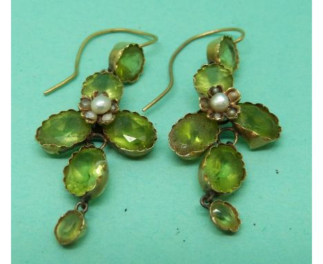 A pair of 15ct gold Edwardian earrings set with oval and round cut peridot and a pearl in a foliate design
