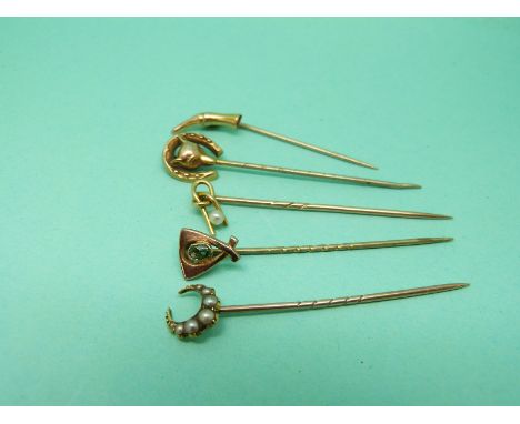 An 18ct gold stick pin set with seed pearls in a crescent, a Victorian stick pin in the form of a fox and horse shoe, a yello