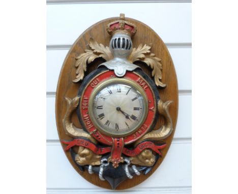 A Smiths 8 day timepiece mounted in a painted metal naval coat of arms Honi Soit Qui Mal y Pense, Dieu et Mon Droit, the silv