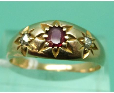 A Victorian ring set with a ruby and two rose cut diamonds in star settings (size R)
