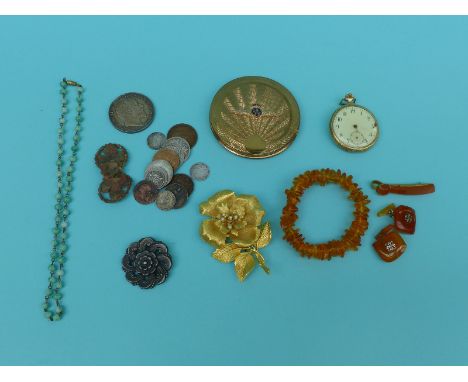 An amber bracelet, amber cufflinks, RAF compact, coins, brooches etc