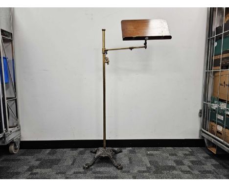 A Victorian music stand, 118cm high plus, finial loose, with wooden music sheet holder on brass support and stem with cast ir