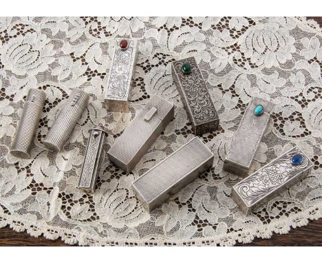 A collection of silver lipstick holders, A collection of silver lipstick holders, two rectangular engine turned examples, one