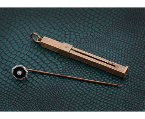 A 9ct gold engine turned toothpick fob, with retractable pick and an art deco pin brooch with enamel octagonal diamond set fr