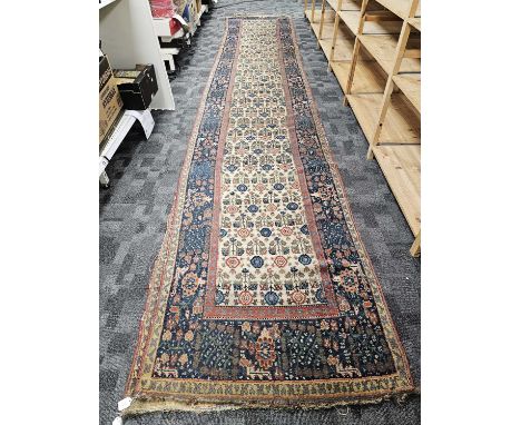 A large vintage woollen runner carpet, As Found, 613cm by 100cm approx, misshapen, repair to one end, other damages and wear 
