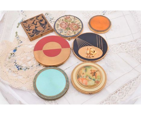 A collection of American circular Rex compacts c1930s and later, including a large black and gilt example with relief mask he