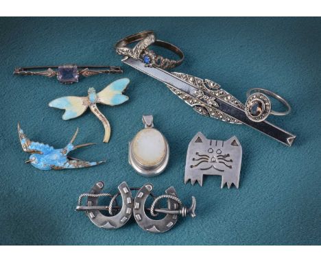 A collection of silver brooches, rings including an enamel butterfly, enamel swallow brooch both af, a silver cat brooch, a m