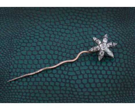 A 19th Century diamond set stick pin, the old cut diamonds in silver setting in the form of a six pointed star, 5cm, 1.1g