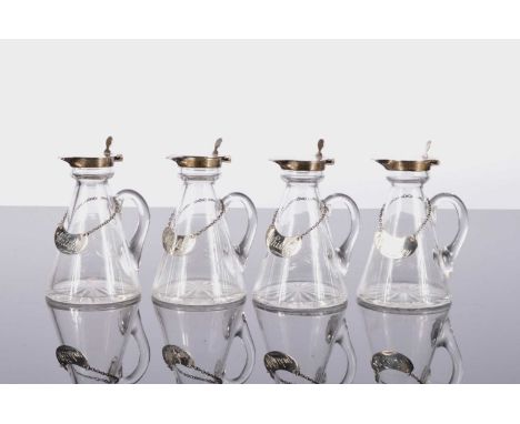 A nice set of four George V period glass and silver Whisky water jugs by Hukin & Heath, each noggin 11cm and marked Birmingha